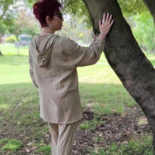 Load image into Gallery viewer, Ada-women's-muslin-hooded-button-front-shirt-in-latte-worn-with-women's-tie-waist-pants-latte-back-view