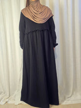 Load image into Gallery viewer, Front view of woman wearing black maxi dress with brown hijab on a white curtain background