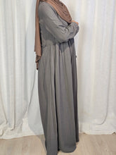 Load image into Gallery viewer, Side view of woman wearing grey maxi dress in front of a white curtain