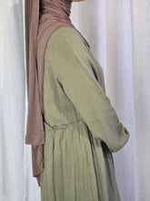 Load image into Gallery viewer, Side close up of woman wearing olive green dress and light brown hijab