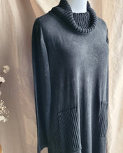 Load image into Gallery viewer, Close up detail of a charcoal gray knit cowl-neck dress with large front patch pockets, displayed on a mannequin against a draped beige fabric backdrop.