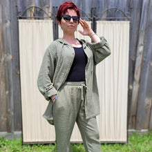 Load image into Gallery viewer, Ada-women's-muslin-hooded-button-front-shirt-in-khaki-worn-with-muslin-tie-waist-pants-khaki-layered-look-with-black-singlet