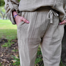 Load image into Gallery viewer, muslin-women's-tie-waist-pants-featuring-elasticated-string-tie-waist-and-side-pockets-in-latte-worn-with-Ada-muslin-hooded-shirt-in-latte-close-up-waist-detail