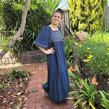 Load image into Gallery viewer, manolya-shirred-maxi-dress-with-bell-sleeves-square-neckline-empire-waist-skirt-with-ruffled-hem-in-teal-outdoor-front-view-image-in-front-of-palm-tree