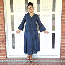 Load image into Gallery viewer, Sharon_tiered_midi_dress_in_teal_with_Vneckline_fitted_buttoned_bust_tiered_skirt_with_lace_trim_at_hem_and_bell_sleeves_with_lace_trim_front_of_white_door