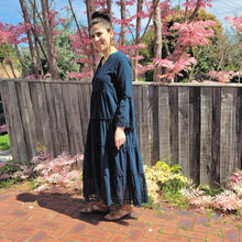 Load image into Gallery viewer, Sharon_tiered_midi_dress_in_teal_with_Vneckline_fitted_buttoned_bust_tiered_skirt_with_lace_trim_at_hem_and_bell_sleeves_with_lace_trim_front_of_pink_tree_side_view