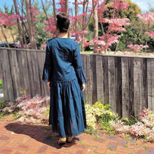 Load image into Gallery viewer, Sharon_tiered_midi_dress_in_teal_with_Vneckline_fitted_buttoned_bust_tiered_skirt_with_lace_trim_at_hem_and_bell_sleeves_with_lace_trim_front_of_pink_tree_back_view