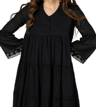 Load image into Gallery viewer, Sharon_tiered_midi_dress_in_black_with_Vneckline_fitted_buttoned_bust_tiered_skirt_with_lace_trim_at_hem_and_bell_sleeves_with_lace_trim_studio_image_close_up