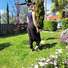 Load image into Gallery viewer, Tribal-harem-pants-in-black-with-ethnic-embroidery-on-front-waist-panel-near-tree-trunk-side-view