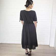 Load image into Gallery viewer, ashley-embroidered-midi-dress-with-embroidery-and-lace-detail-on-bodice-and-front-pockets-and-lace-on-hem-trim-in-black-back-view