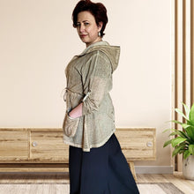 Load image into Gallery viewer, delta-hooded-tunic-with-button-tab-long-sleeves-drawstring-waist-and-front-pockets-in-light-brown-side-view