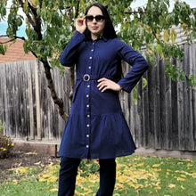 Load image into Gallery viewer, sile-cotton-button-through-tunic-dress-in-navy-with-shirt-collar-fabric-belt-ruffle-hem-and-long-sleeves-with-button-tabs