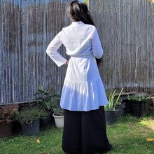 Load image into Gallery viewer, sile-cotton-button-through-tunic-dress-in-white-with-shirt-collar-fabric-belt-ruffle-hem-and-long-sleeves-with-button-tabs