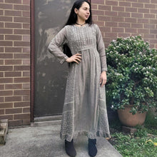 Load image into Gallery viewer, long-sleeve-cotton-maxi-dress-in-mocha-with-eyelet-embroidery-on-front-sides-pintuck-detail-on-chest-lace-frill-at-skirt-hem-and-string-tie-at-waist-back