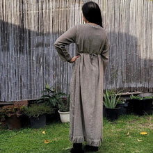 Load image into Gallery viewer, long-sleeve-cotton-maxi-dress-in-mocha-with-eyelet-embroidery-on-front-sides-pintuck-detail-on-chest-lace-frill-at-skirt-hem-showing-string-tie-at-waist-back