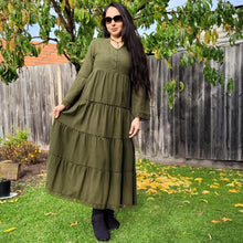 Load image into Gallery viewer, brushed-cotton-flannel-tiered-maxi-dress-in-khaki-with-V-neck-buttoned-chest-bell-sleeves-with-tassel-ties-lace-trim-on-sleeves-and-skirt-hem-and-string-tie-waist