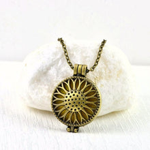 Load image into Gallery viewer, vintage-look-bronze-aromatherapy-essential-oils-diffuser-filigree-style-sunflower-design-pendant-necklace-jewellery-pendant-close-up