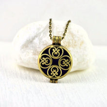 Load image into Gallery viewer, vintage-look-bronze-aromatherapy-essential-oils-diffuser-locket-necklace-close-up-view-of-round-filigree-style-geometric-design-pendant
