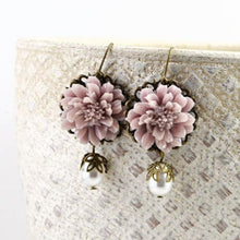 Load image into Gallery viewer, vintage-style-dusty-pink-lotus-flower-bronze-earrings-with-swarovski-pearl-drops-hanging-from-textured-bowl
