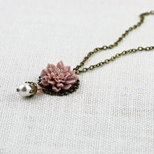 Load image into Gallery viewer, vintage-style-dusty-pink-lotus-flower-bronze-necklace-with-swarovski-pearl-drop-detail-on-flat-surface