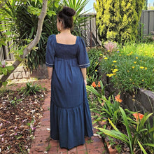 Load image into Gallery viewer, manolya-shirred-maxi-dress-with-bell-sleeves-square-neckline-empire-waist-skirt-with-ruffled-hem-in-teal-outdoor-back-view-image-in-front-of-palm-tree
